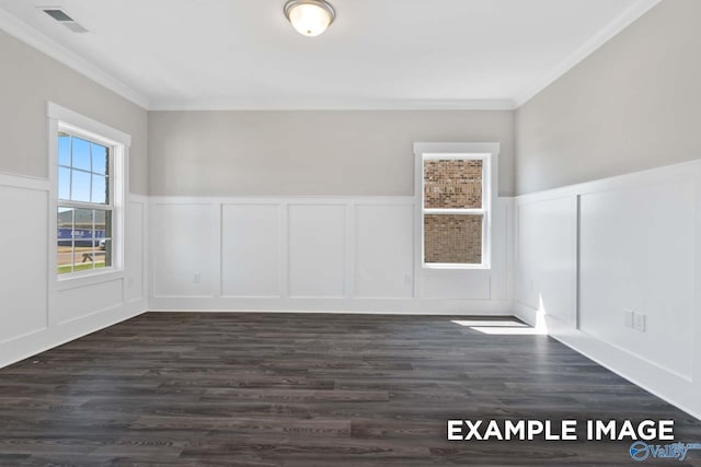 empty room with dark wood-style floors, visible vents, and ornamental molding