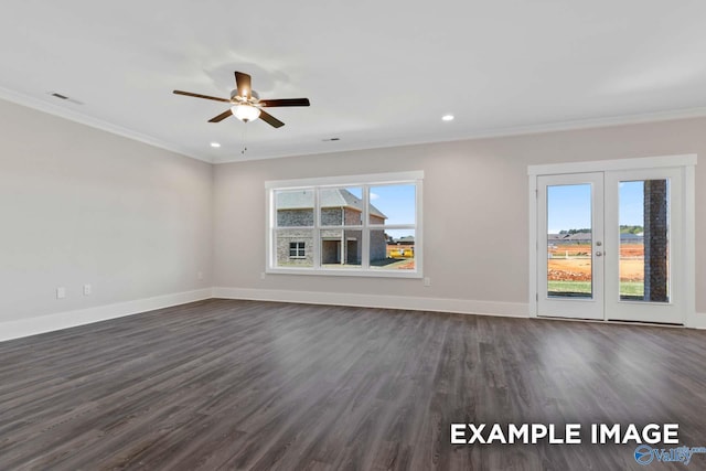 unfurnished room featuring crown molding, dark wood finished floors, and baseboards