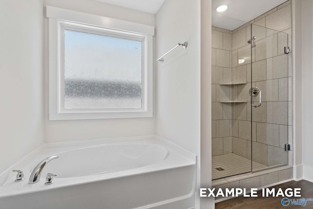 full bathroom with a stall shower and a bath