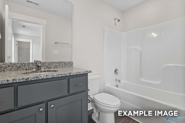 bathroom featuring toilet,  shower combination, vanity, and visible vents