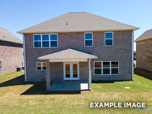 rear view of property with cooling unit, a shingled roof, a yard, french doors, and a patio area