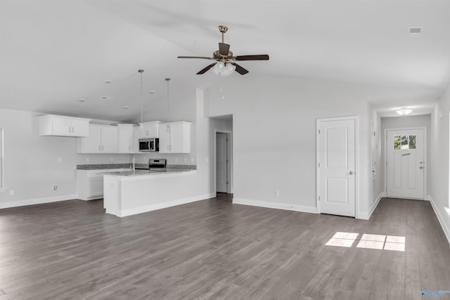 unfurnished living room with high vaulted ceiling, dark wood-style floors, baseboards, and ceiling fan