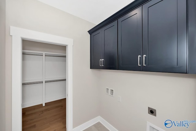 laundry room with washer hookup, wood finished floors, cabinet space, baseboards, and hookup for an electric dryer