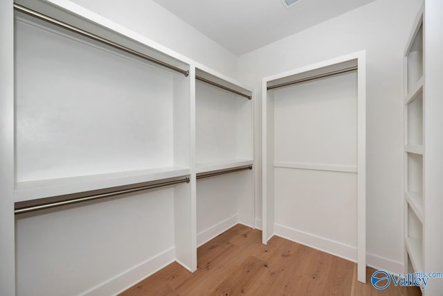 spacious closet with visible vents and light wood-style floors