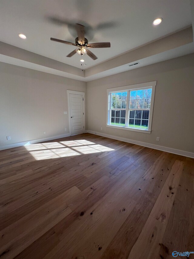 empty room featuring recessed lighting, visible vents, baseboards, and hardwood / wood-style floors