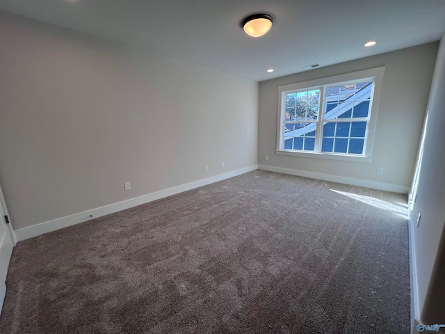 carpeted empty room featuring recessed lighting, baseboards, and visible vents