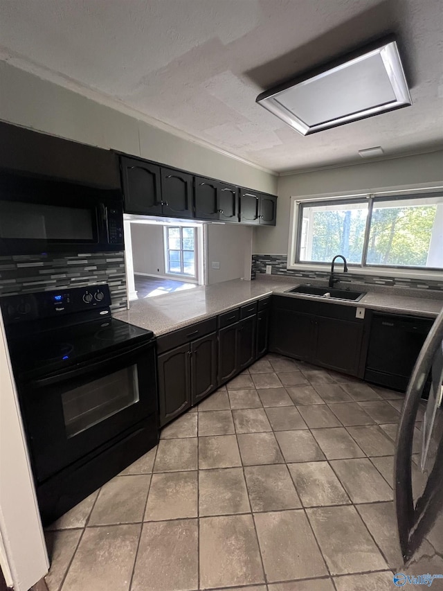 508 Mary St, Centre, AL 35960 - kitchen with backsplash, a sink, light tile patterned floors, light countertops, and black appliances