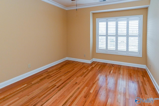 unfurnished room featuring crown molding and light hardwood / wood-style floors