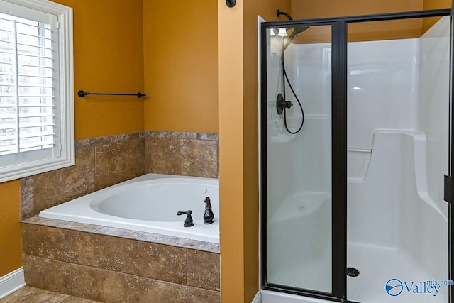 bathroom featuring independent shower and bath