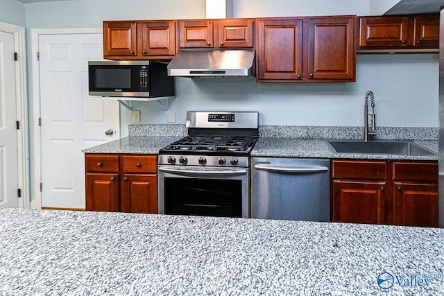 kitchen featuring sink, stainless steel appliances, and exhaust hood