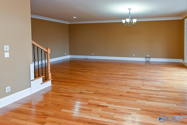 unfurnished room with crown molding, a chandelier, and light hardwood / wood-style floors