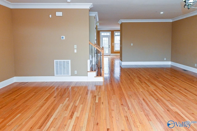 unfurnished room featuring crown molding and light wood-type flooring