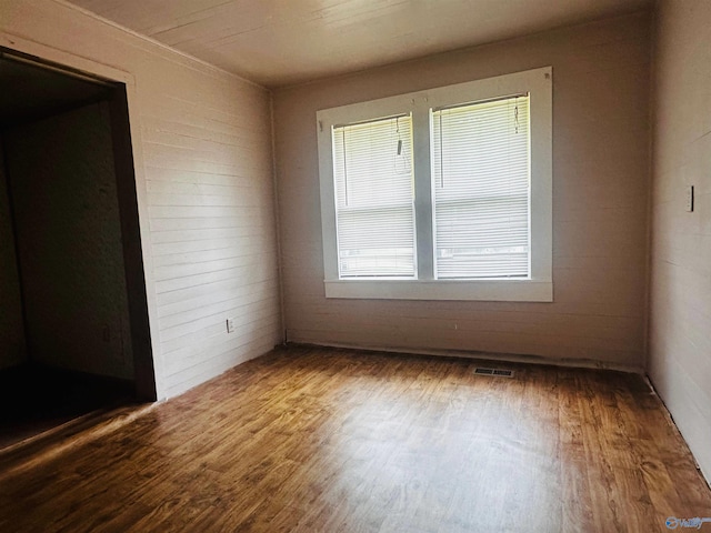 unfurnished room with wood-type flooring