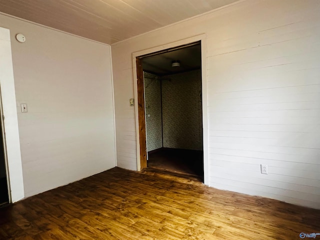 unfurnished room with wood-type flooring