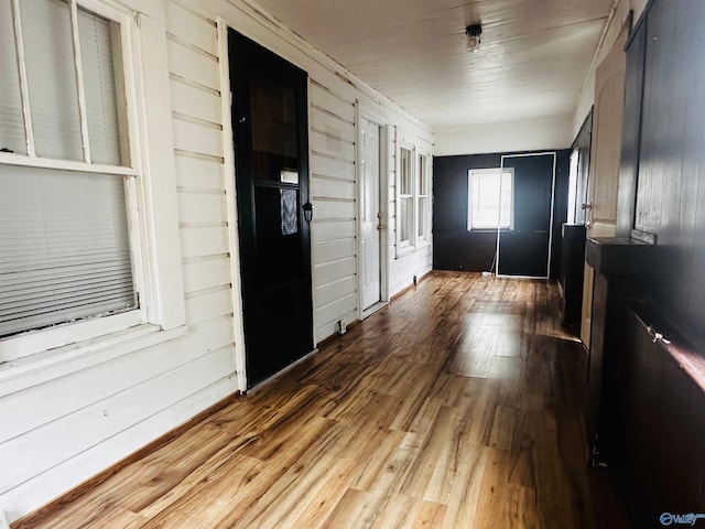 hallway with hardwood / wood-style flooring