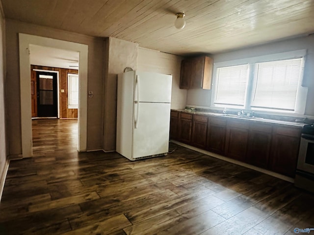 kitchen featuring range with electric stovetop, white refrigerator, dark hardwood / wood-style flooring, and dark brown cabinets