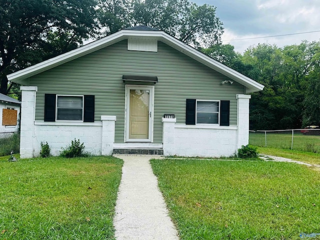 bungalow-style home with a front lawn