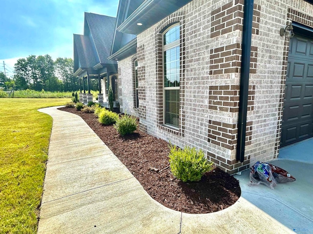 view of side of property with a garage and a yard