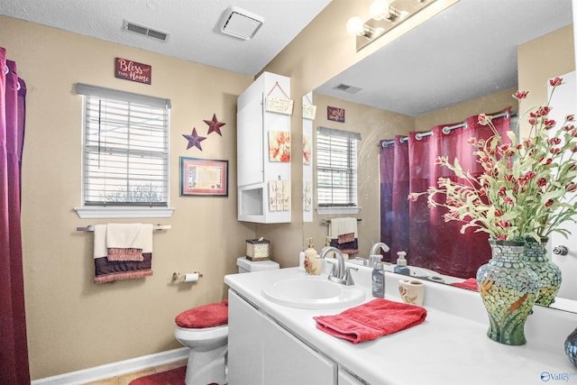 bathroom with toilet, a shower with curtain, visible vents, and vanity