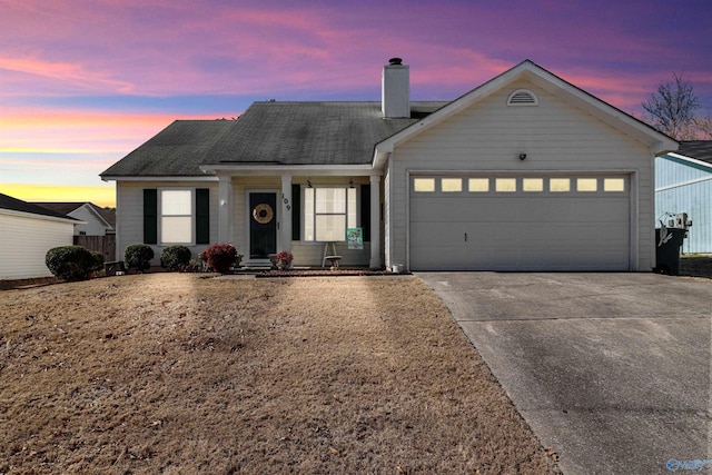 ranch-style house featuring a garage, driveway, a chimney, and roof with shingles