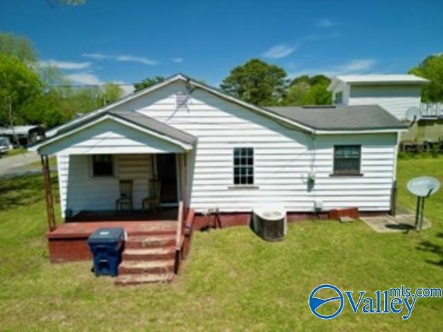 back of property featuring a lawn