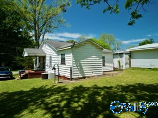 rear view of house with a lawn