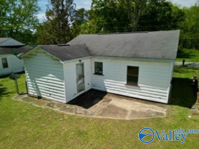 rear view of property with a lawn and a patio area