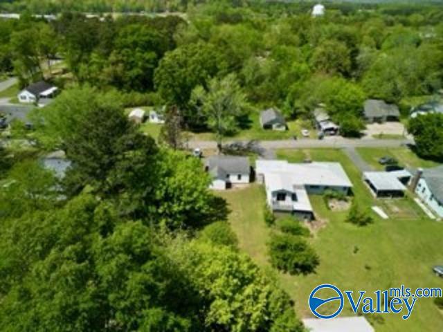 drone / aerial view featuring a wooded view