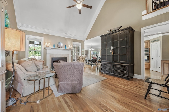 23245 Piney Creek Dr, Athens, AL 35613 - living area featuring a ceiling fan, a fireplace, high vaulted ceiling, light wood-style floors, and a chandelier