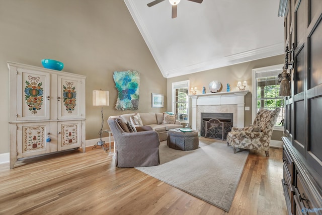 23245 Piney Creek Dr, Athens, AL 35613 - living room with crown molding, a tiled fireplace, healthy amount of natural light, light wood-style floors, and ceiling fan