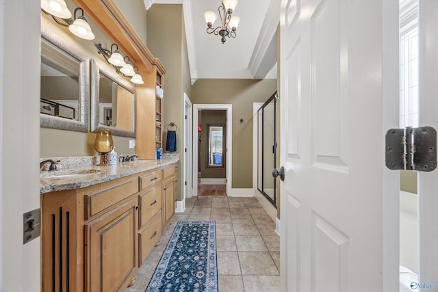 23245 Piney Creek Dr, Athens, AL 35613 - bathroom with a chandelier, double vanity, a shower stall, healthy amount of natural light, and ornamental molding