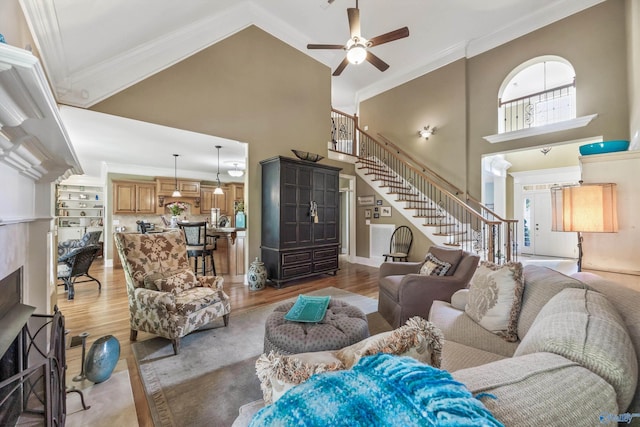 23245 Piney Creek Dr, Athens, AL 35613 - living room featuring stairway, high vaulted ceiling, ornamental molding, ceiling fan, and wood finished floors