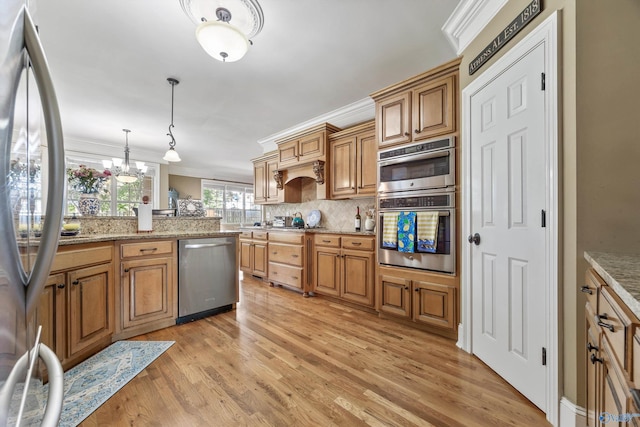 23245 Piney Creek Dr, Athens, AL 35613 - kitchen with stainless steel appliances, backsplash, light wood finished floors, decorative light fixtures, and crown molding