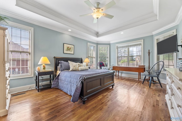 23245 Piney Creek Dr, Athens, AL 35613 - bedroom featuring a raised ceiling, multiple windows, wood finished floors, crown molding, and recessed lighting