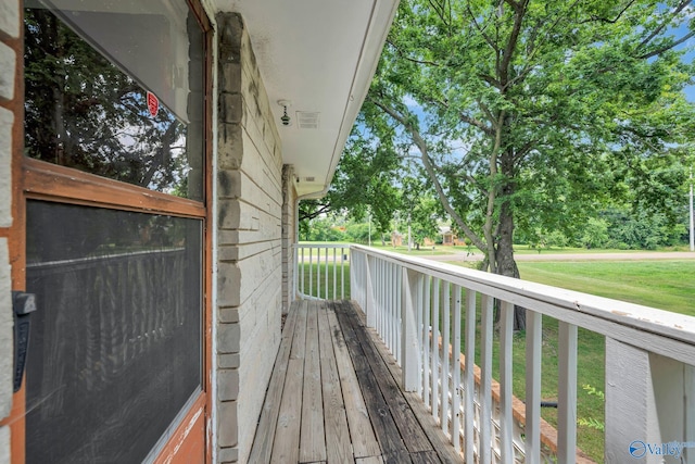 wooden deck featuring a yard