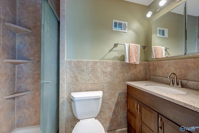 bathroom featuring vanity, decorative backsplash, tile walls, and toilet