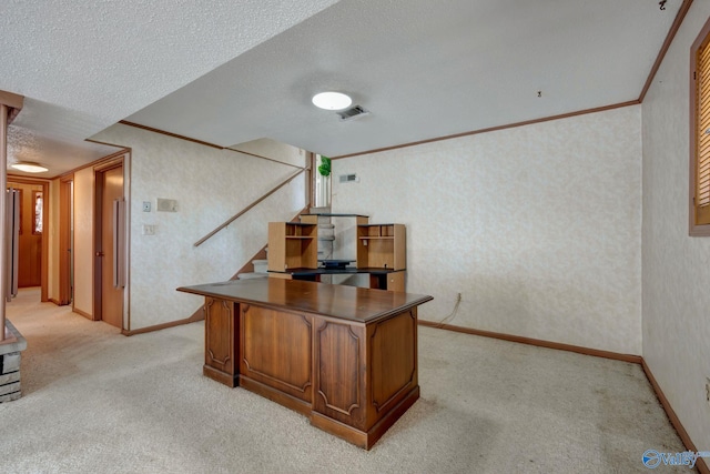 carpeted office featuring ornamental molding and a textured ceiling