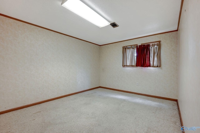 carpeted empty room featuring ornamental molding