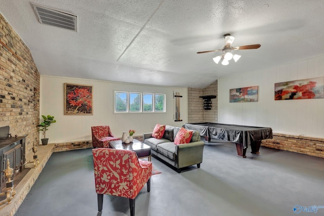 living room featuring pool table, concrete flooring, a textured ceiling, and lofted ceiling