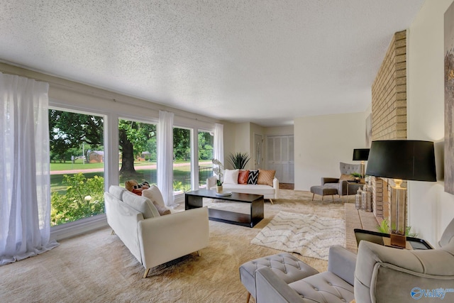 carpeted living room featuring brick wall and a textured ceiling