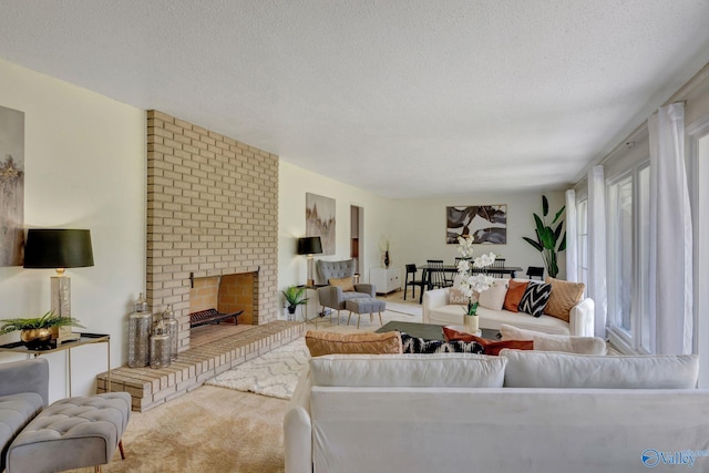 carpeted living room featuring brick wall, a brick fireplace, and a textured ceiling