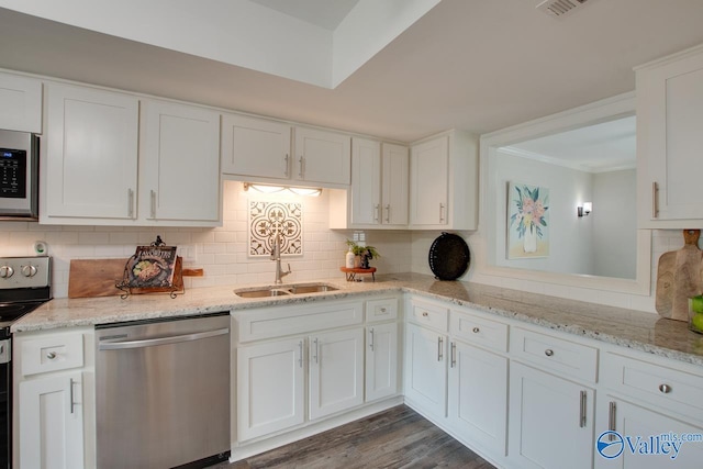 1908 Spanish Oaks Dr SE, Huntsville, AL 35803 - kitchen featuring appliances with stainless steel finishes, white cabinets, backsplash, crown molding, and light stone countertops