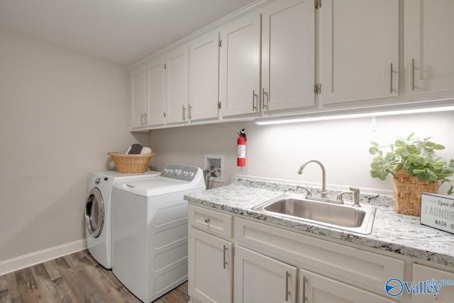 1908 Spanish Oaks Dr SE, Huntsville, AL 35803 - laundry room with cabinet space, washing machine and dryer, and light wood-style flooring