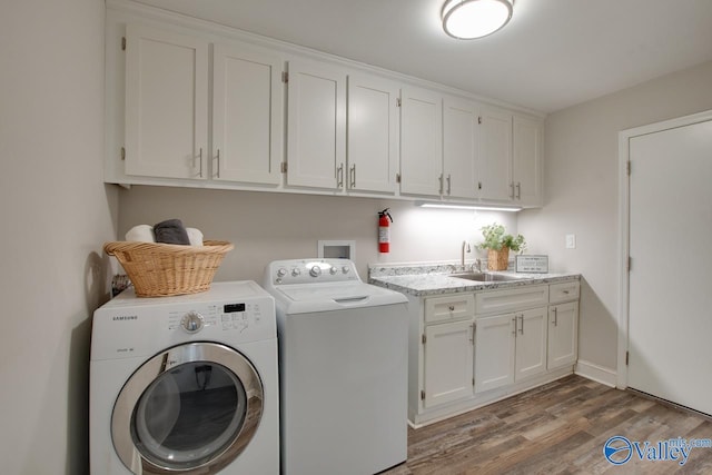 1908 Spanish Oaks Dr SE, Huntsville, AL 35803 - washroom featuring separate washer and dryer, light wood-style floors, and cabinet space