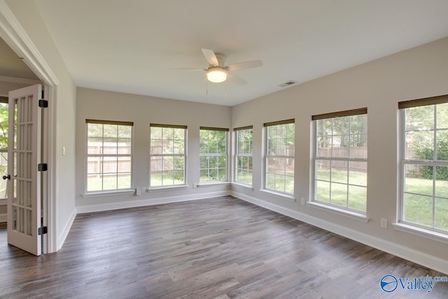 1908 Spanish Oaks Dr SE, Huntsville, AL 35803 - unfurnished sunroom featuring baseboards and wood finished floors