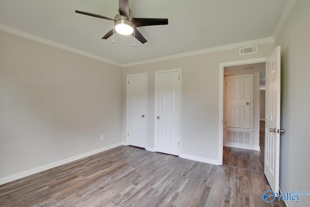 1908 Spanish Oaks Dr SE, Huntsville, AL 35803 - unfurnished bedroom with wood finished floors, ornamental molding, and ceiling fan