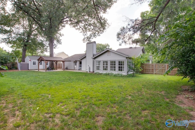 1908 Spanish Oaks Dr SE, Huntsville, AL 35803 - back of house with a chimney, a patio, a fenced backyard, a gazebo, and a storage unit