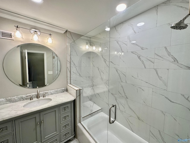 bathroom with vanity and bath / shower combo with glass door