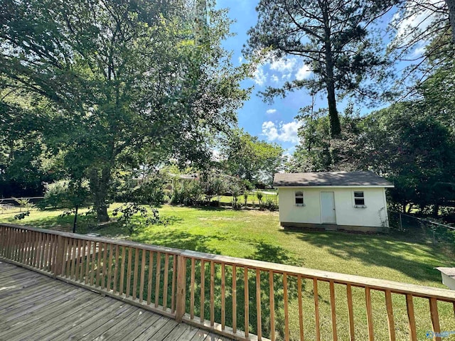 deck with a yard and an outbuilding