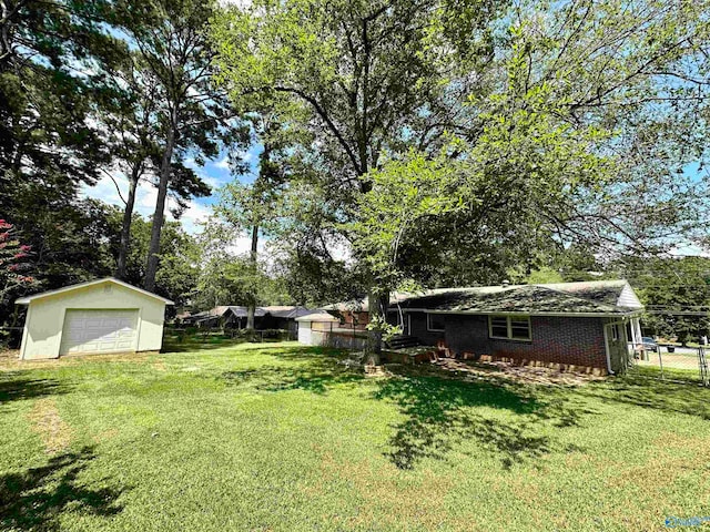 view of yard with an outbuilding and a garage